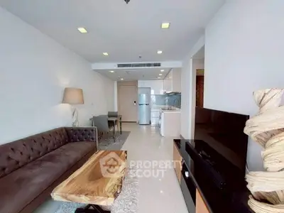 Modern living room with stylish furniture and open kitchen layout in a contemporary apartment.