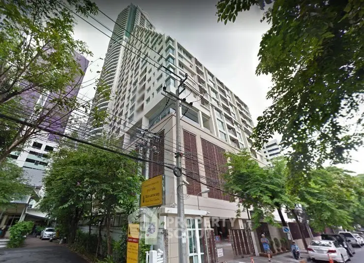 Modern high-rise building with lush greenery and urban surroundings