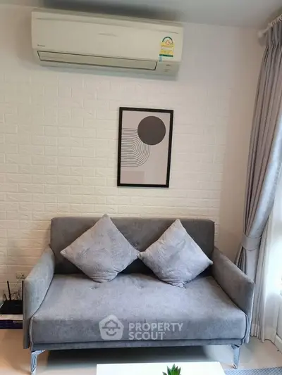 Cozy living room with modern gray sofa and stylish wall art