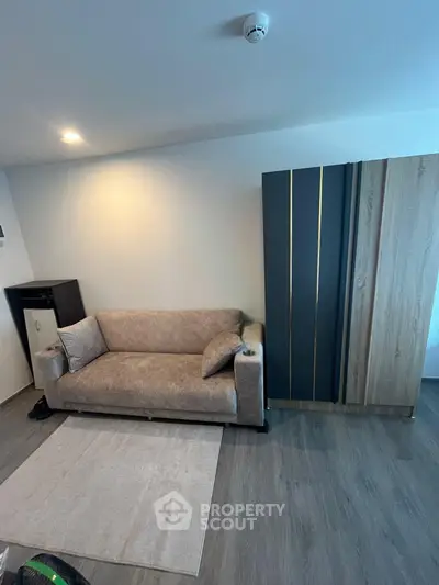 Modern living room with stylish sofa and sleek wardrobe in a contemporary apartment.