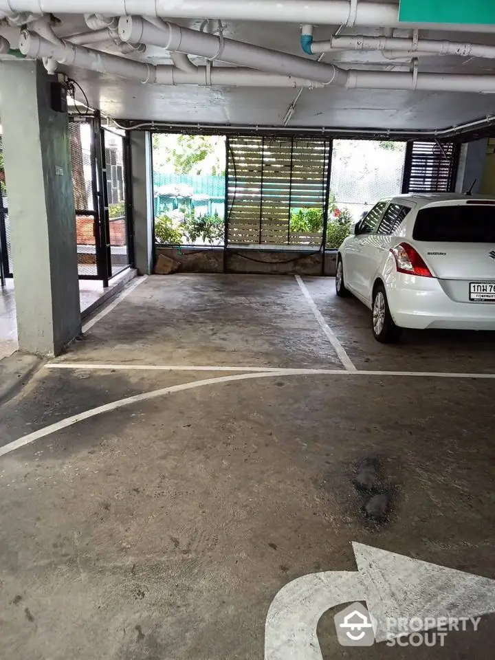 Spacious indoor parking area with natural light and secure environment.