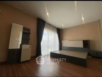 Spacious bedroom with modern design and large window for natural light