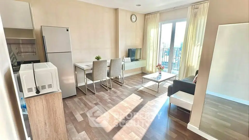Bright modern living room with dining area and city view, featuring sleek furniture and natural light.