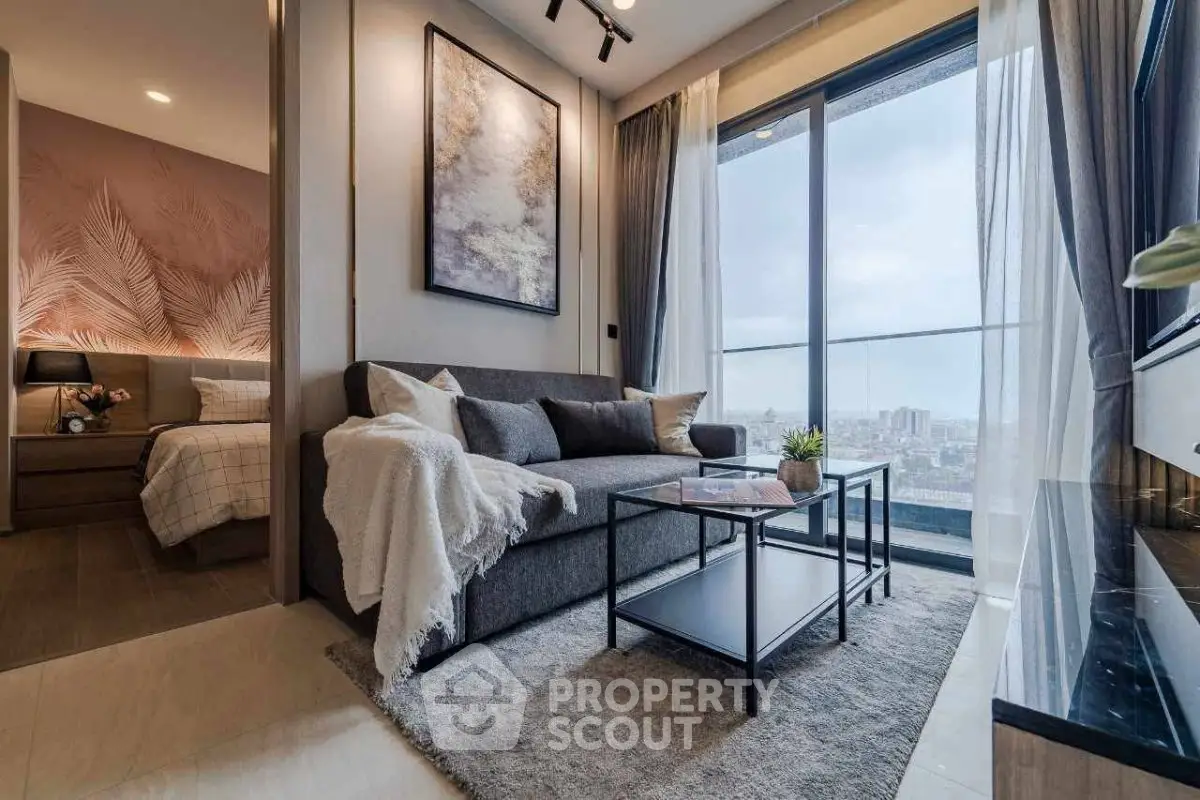 Modern living room with cozy sofa and stunning city view from large window.