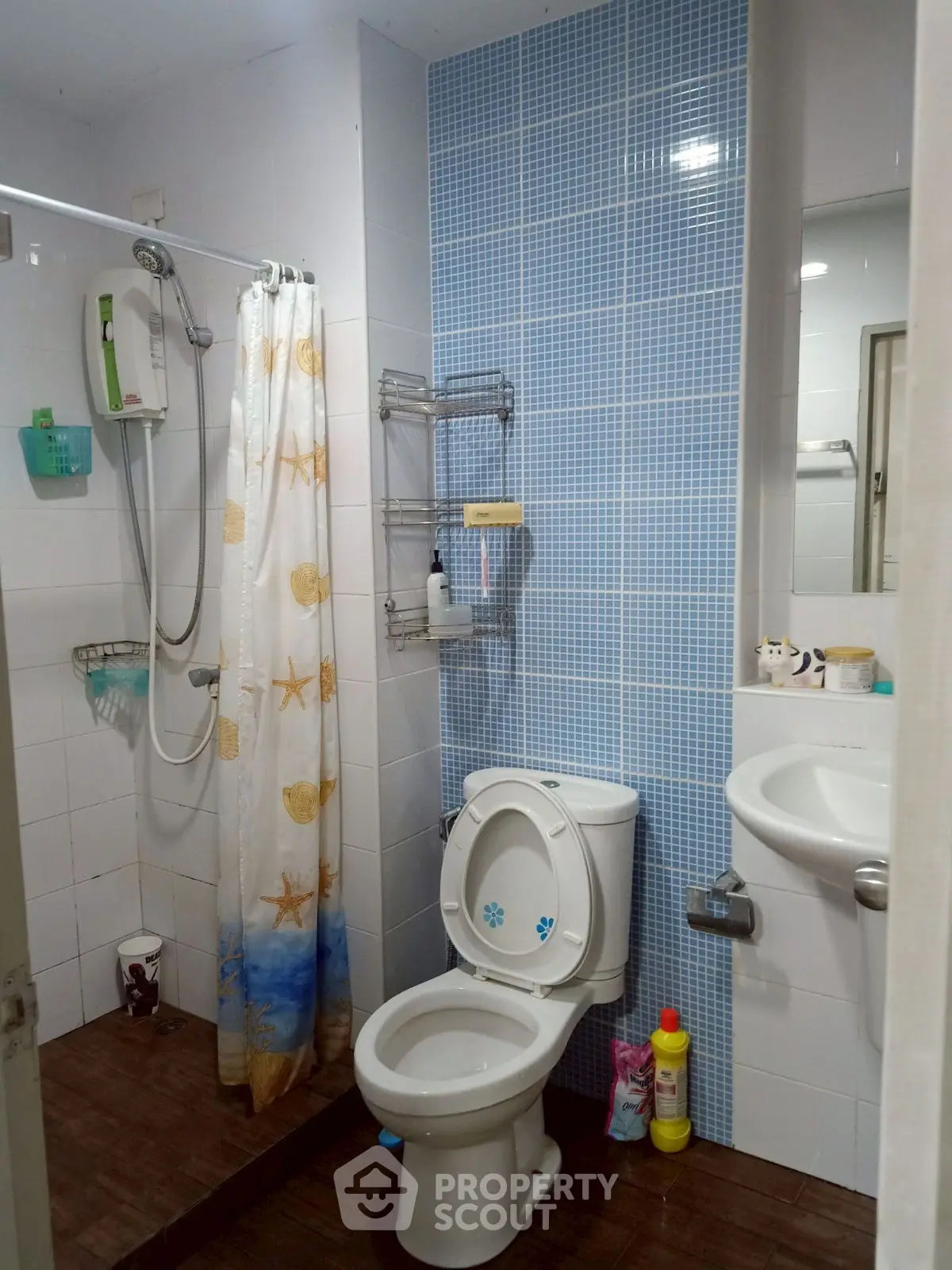 Cozy bathroom with shower and modern fixtures, ideal for compact living spaces.