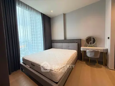 Modern bedroom with large window and stylish furniture in a high-rise apartment.