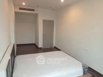 Spacious bedroom with minimalist design and natural lighting