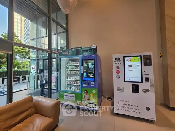 Modern building entrance with vending machines and glass facade