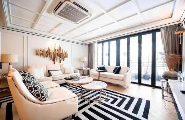 Luxurious living room with modern decor and large windows for natural light.