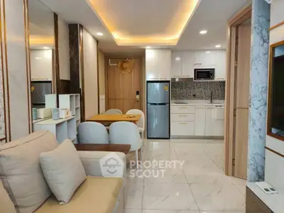 Modern open-plan living room and kitchen with sleek design and cozy ambiance.