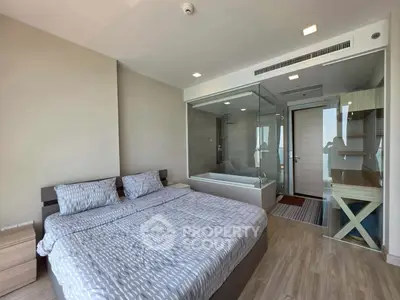 Modern bedroom with glass-enclosed bathroom and stylish decor