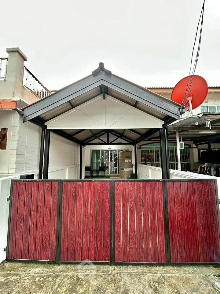 Charming residential entrance with modern gate and covered carport