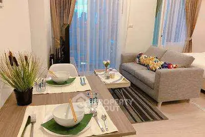 Cozy living room with dining area and modern decor in a stylish apartment.