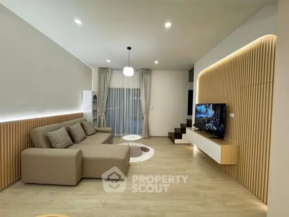 Modern living room with stylish decor and wall-mounted TV
