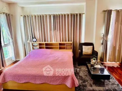 Spacious bedroom with cozy decor and natural light, featuring a comfortable bed and stylish furnishings.