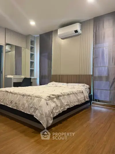 Modern bedroom with wooden flooring and stylish decor