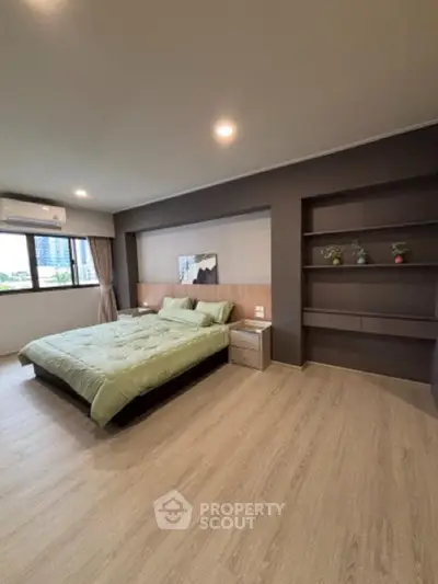 Spacious modern bedroom with large window and stylish decor