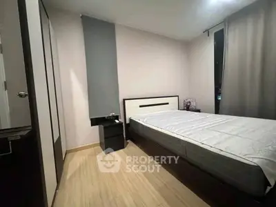 Modern bedroom with sleek design and cozy ambiance, featuring a comfortable bed and stylish decor.