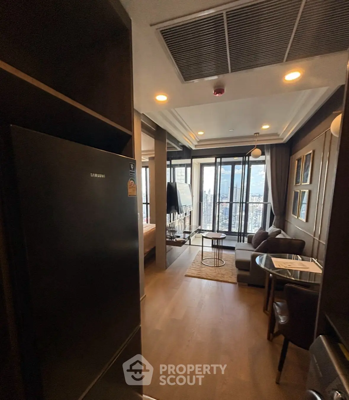 Modern apartment interior with city view, featuring open layout and stylish decor.