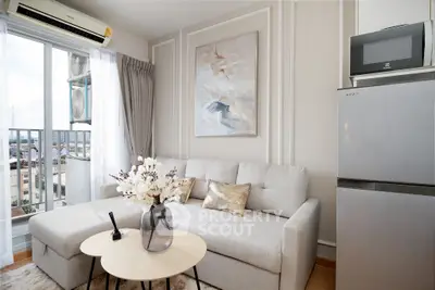 Modern living room with cozy sofa, elegant decor, and balcony view in a stylish apartment.