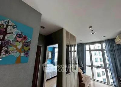 Spacious modern apartment with large windows and stylish decor in a vibrant urban setting.