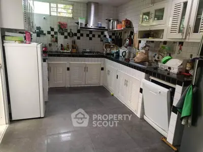 Spacious kitchen with modern appliances and ample storage in a stylish home.