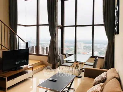 Luxurious high-rise living room with panoramic city views and elegant decor.