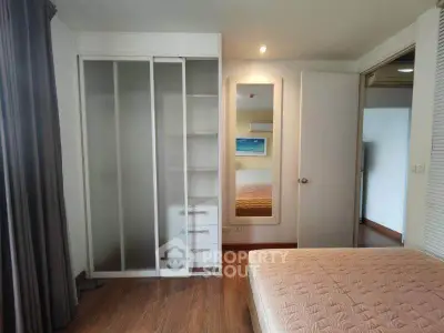 Spacious bedroom with built-in wardrobe and cozy ambiance