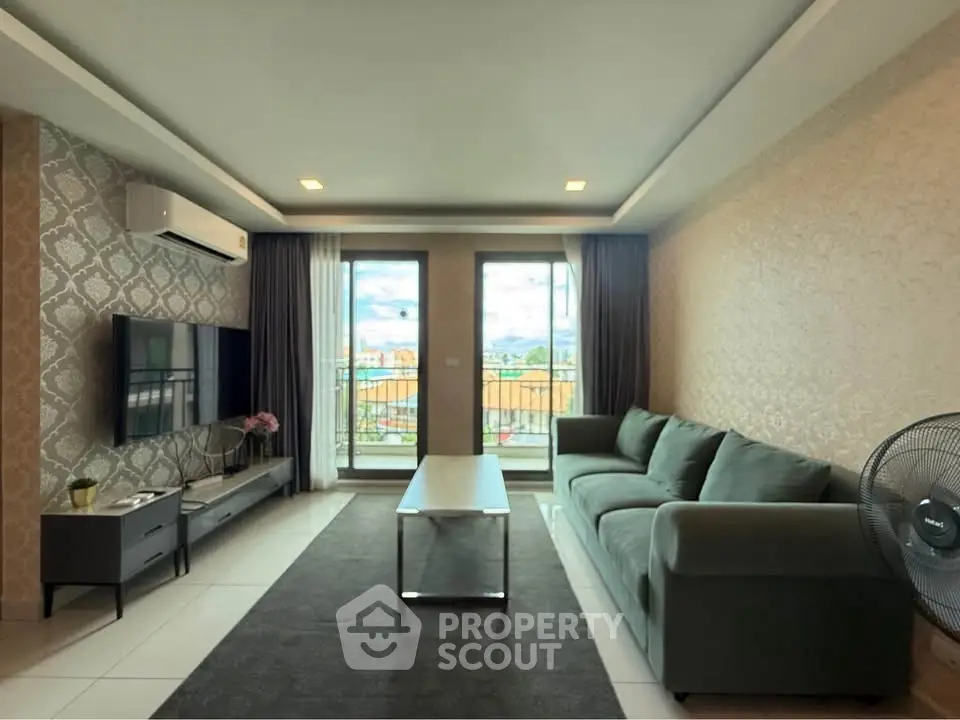 Spacious living room with modern decor and balcony view