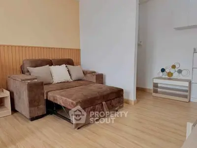 Cozy living room with brown sofa and modern decor, perfect for relaxation.
