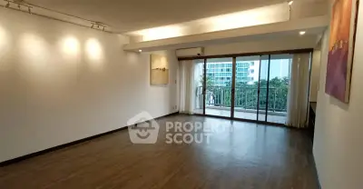Spacious living room with large windows and balcony access in modern apartment.