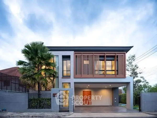 Modern two-story house with large windows and sleek design