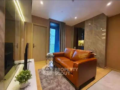 Modern living room with leather sofa and stylish decor in a cozy apartment.
