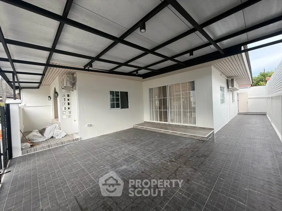 Spacious modern home exterior with covered patio and sleek design.