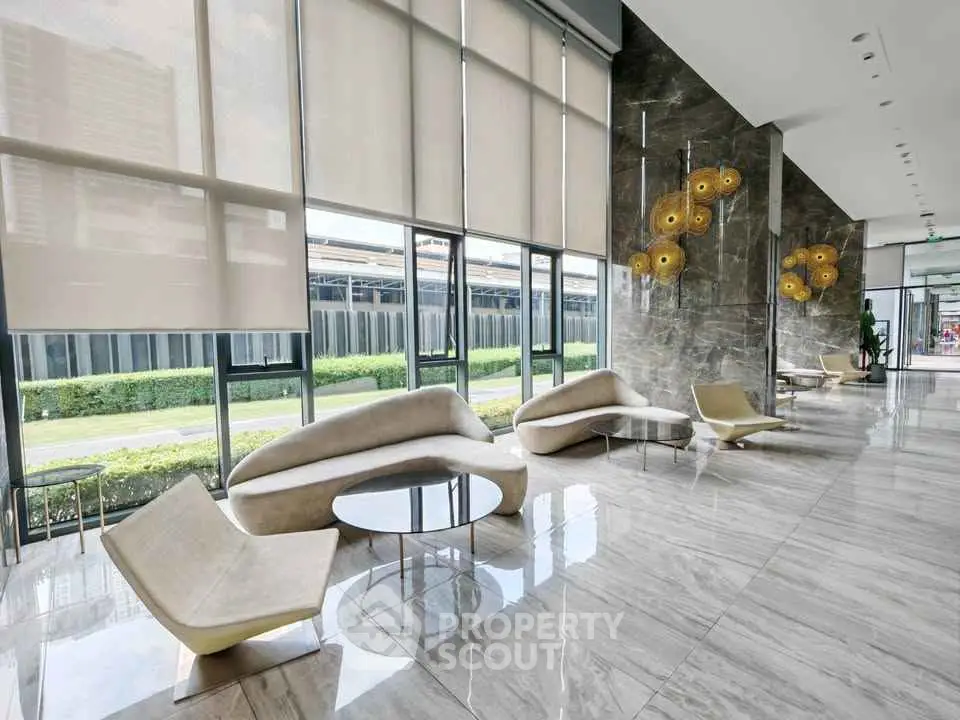Luxurious modern lobby with elegant seating and floor-to-ceiling windows offering garden views.