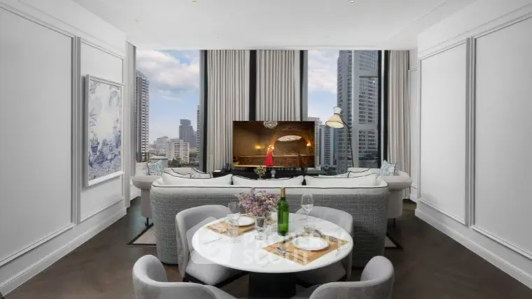 Luxurious living room with city view, elegant decor, and cozy dining area.