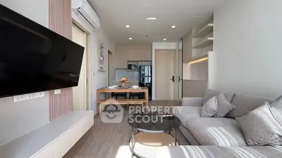 Modern living room with sleek furniture and open kitchen layout, perfect for urban living.