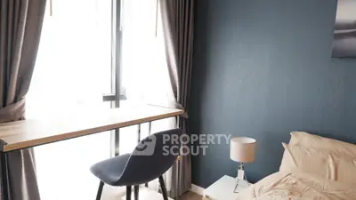 Cozy bedroom with natural light, modern furniture, and elegant color scheme, perfect for relaxation and comfort.