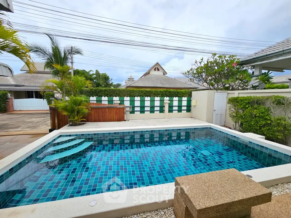 Charming backyard pool with lush greenery and modern design, perfect for relaxation and entertainment.