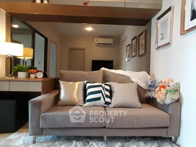 Cozy living room with stylish sofa and decorative pillows in modern apartment.