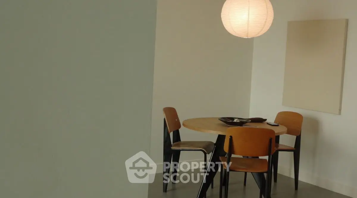 Modern dining area with stylish chairs and pendant light