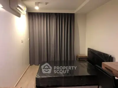 Modern bedroom with minimalist design and sleek furniture in a cozy apartment.