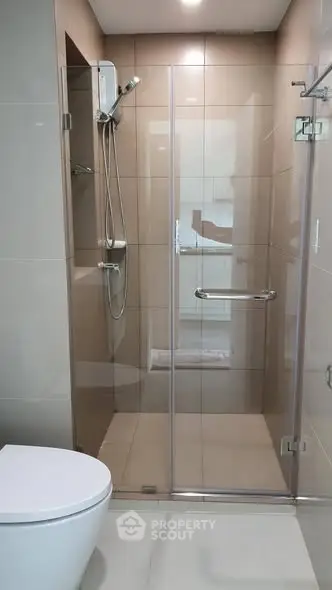 Modern bathroom with glass shower enclosure and sleek fixtures