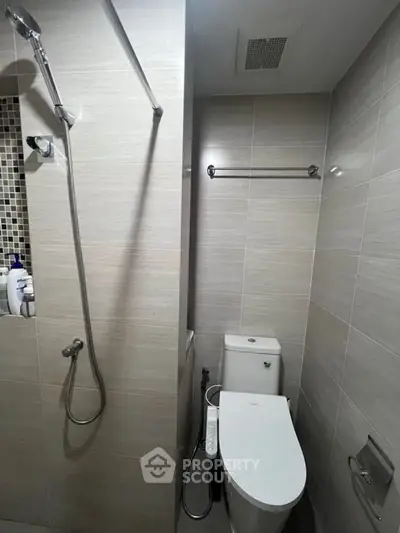 Modern bathroom with sleek shower and toilet in compact design