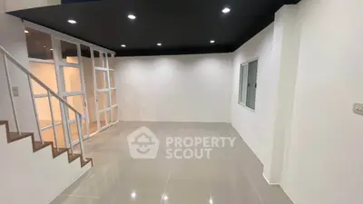 Modern minimalist interior with sleek staircase and glass partition