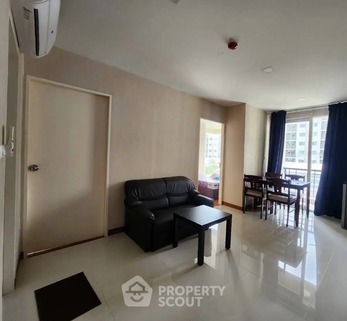 Spacious living room with modern furniture and large windows offering natural light