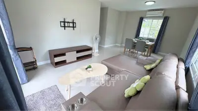 Spacious living room with modern furniture and dining area, perfect for family gatherings.