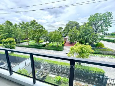 Spacious balcony with stunning garden view in modern residential area.