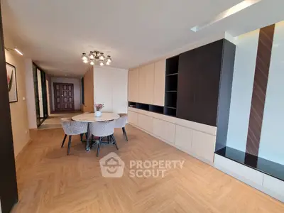 Spacious modern living room with elegant dining area and built-in storage