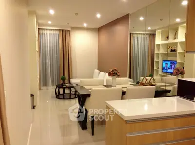 Modern living room with elegant decor and open layout, featuring a cozy seating area and stylish dining space.